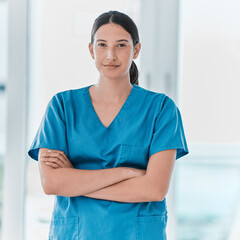 Poster - I will assist you as best as I can. Portrait of a young doctor standing with her arms crossed in a hospital.
