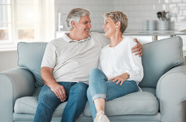 Poster - Your smile makes me smile. Shot of a happy senior couple relaxing on the sofa at home.