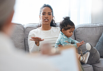 Canvas Print - Shes fidgety all the time. Shot of an attractive young woman sitting with her daughter during a consultation with a psychologist.