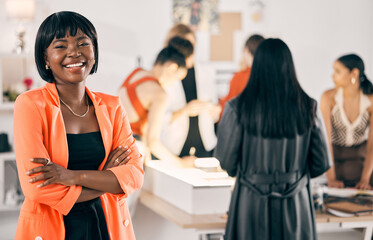 Aufkleber - United by passion. Shot of a young woman standing with her arms crossed while her coworkers collaborate in the background.