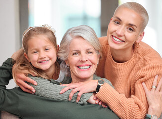 Sticker - Through the years. Portrait of a mature woman bonding with her daughter and granddaughter on the sofa at home.