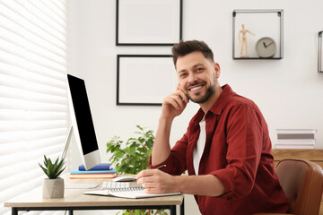 Wall Mural - Portrait of man studying near computer at home. Online translation course