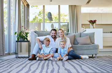 Poster - Family comes first. Full length portrait of an affectionate mature couple and their kids sitting in the living room at home.