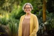 © Hanne Bauer - Portrait of smiling senior woman with eyeglasses in the garden