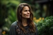 © Leon Waltz - Portrait of a beautiful young woman smiling at the camera in the garden