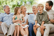 © Siphosethu Fanti/peopleimages.com - Happy and smiling multi generation caucasian family sitting close together on the sofa at home. Happy adorable children bonding with their mother, father, grandfather and grandmother on a weekend