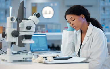 Poster - Counting down the hours. Shot of a young woman looking bored while at work in her lab.