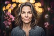 © Robert MEYNER - Portrait of a beautiful middle-aged woman with flowers in the background