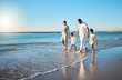 © Kirsten D/peopleimages.com - Taking a summertime trip to the beach. Shot of a happy family walking together on the beach.