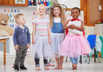 Poster - We love dressing up and playing together. Shot of a group of preschool children playing dress-up in class.