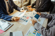 © Witoon - Asian business team at a meeting to analyze and discuss the situation on financial reports in the conference room investment advisor financial advisor financial advisor and accounting concept.