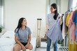 © Kawee - Asian young amputee leg woman and friend choosing clothes on closet rack.