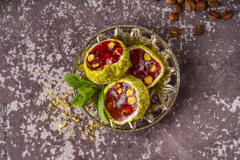Plate with tasty Turkish Delight on grunge background