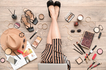 Wall Mural - Woman with laptop and accessories sitting on light wooden floor