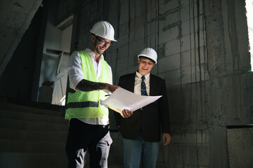 Wall Mural - Contractor and engineer architect working together planning using blueprint design structure construction industry, building house innovation and teamwork discussing, two male caucasian collaborating.