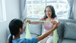 © NanSan - Asian Chinese female physiotherapist caregiver helping elderly woman exercise for recovery, prevention of osteoarthritis and osteoporosis.