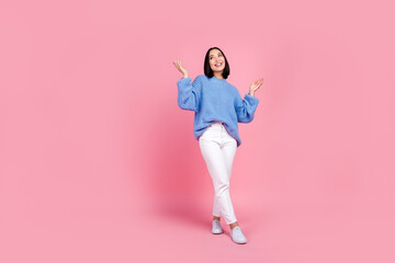 Full length portrait of cheerful satisfied person raise arms empty space isolated on pink color background