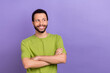 Portrait of cheerful minded person folded hands toothy smile look empty space isolated on purple color background