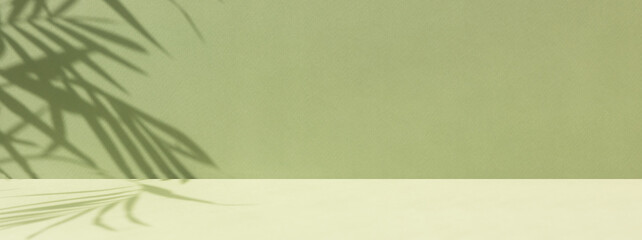 Minimal abstract background for the presentation of a cosmetic product. Empty premium podium with a shadow of tropical palm leaves on a green background. Showcase, display case.