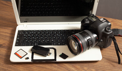 Modern DSLR camera and laptop computer.