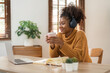 © Natee Meepian - Holiday and leisure ideas of young African women drinking morning coffee at home