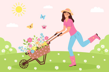 Happy woman pushing garden cart with flowers on the meadow. Sunny landscape with floral wheelbarrow, female gardener and butterflies. Agriculture, farming, gardening, spring or summer concept.