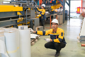 Professional heavy industry engineer worker wearing safety uniform in a metal manufacture warehouse , maintenance service check for safety first concept .