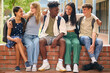 © Monkey Business - Portrait Of Multi-Cultural Secondary Or High School Students Sitting On Wall Outdoors At School
