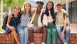 © Monkey Business - Portrait Of Multi-Cultural Secondary Or High School Students Sitting On Wall Outdoors At School