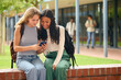 © Monkey Business - Two Female Secondary Or High School Students Outdoors At School Looking At Mobile Phone