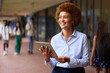 © Monkey Business - Smiling Female High School Or Secondary School Teacher With Digital Tablet Outdoors At School