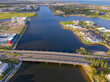 © Austockphoto - Aerial view of a bridge crossing a canal with real estate developments on ether side