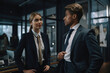 © Andrii  - Woman and man wearing a suit and talking to each while standing in a modern office. Generative AI