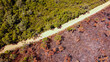 © Austockphoto - Bush fire aftermath drone shot in western Australia. One side of road healthy and green other burnt