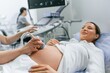 © standret - Close up view, scanning. Pregnant woman is lying down in the hospital, doctor does ultrasound