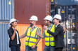© lukyeee_nuttawut - group of businessman, Logistics engineer and inspector and businessman cheer up  and happy to about success business deal and project in shipping containerin commercial transport port