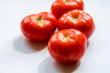 Wall Mural - bunch of red tomatoes close up on white background