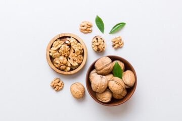 Wall Mural - Walnut kernel halves, in a wooden bowl. Close-up, from above on colored background. Healthy eating Walnut concept. Super foods with copy space