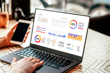 Analyst woman works on a laptop, shows statistics, graphs