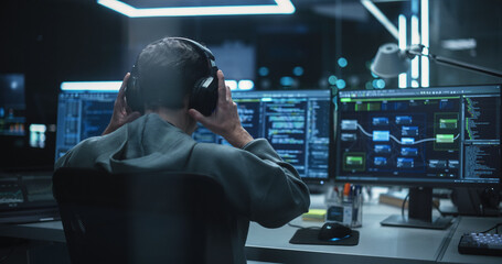 Wall Mural - Young Hacker Working Alone, Hacking Corporate Data Servers From His Underground Hideout. Hacktivist Organizes a Massive Data Breach Cyber Attack, Hiding His Identity Behind Multiple Proxy Servers