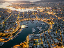 Aerial View Of The Illuminated Zea Marina In Piraeus, Athens, Greece, With Lined Up Sailing Boats And Yachts During Evening