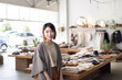 © Trinette Reed - Portrait of Japanese small business woman owner in clothing retail store.