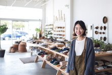 Portrait Of Asian Small Business Woman Owner In Clothing Retail Store. Generative AI.