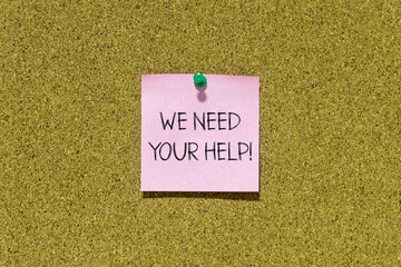 Poster - We need your help text on pink post-it paper pinned on bulletin cork board. This message can be used in business concept about needing your help.