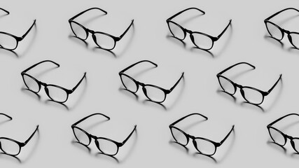 Modern black framed reading glasses or spectacles repeated on a gray colored background with minimalist style.