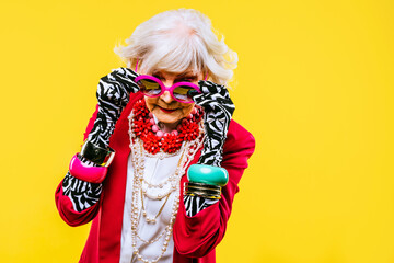 Cool and stylish senior old woman with fashionable clothes - Elderly funny female with stylish colorful dress portrait on isolated colored background