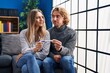 © Krakenimages.com - Young couple holding pregnancy test result smiling looking to the side and staring away thinking.