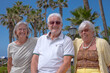 © luciano - Group of Happy Senior People Sitting Under the Sun close to the Beach Enjoying Sea Vacation and Freedom. Retirement Lifestyle Concept