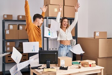 Wall Mural - Young man and woman ecommerce business workers throwing documents at office