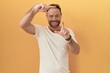 © Krakenimages.com - Middle age man with beard standing over yellow background smiling making frame with hands and fingers with happy face. creativity and photography concept.